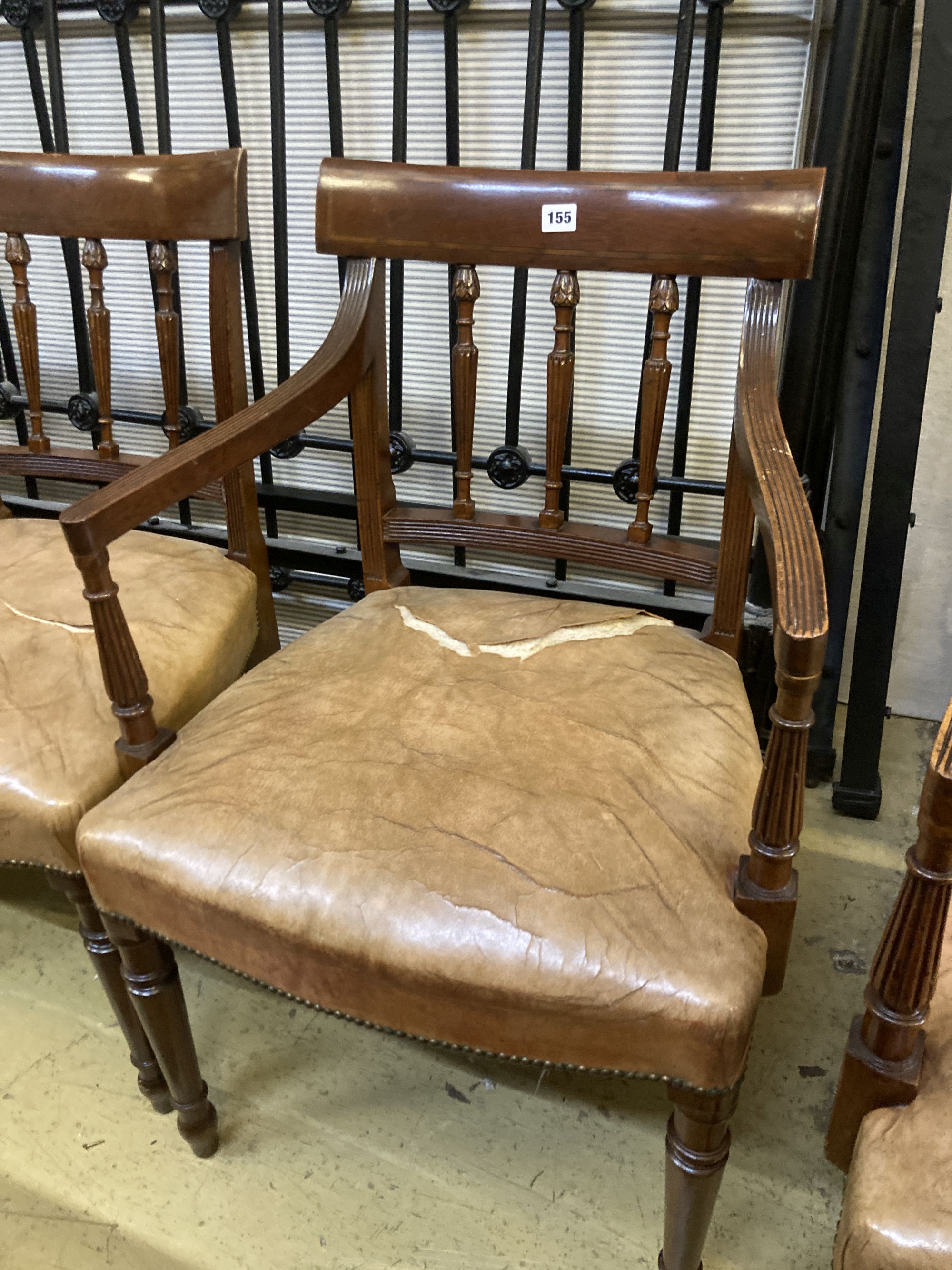 A set of eight George III style Sheraton design mahogany dining chairs, with leather stuff-over seats